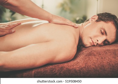 Handsome Man Having Massage In Spa Salon