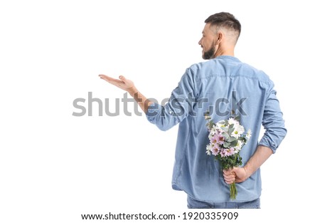 Similar – Man in jeans and plaid shirt with some white flowers in his hand