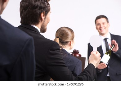 Handsome Man Holding Bottle Of Wine. Person Selling Expensive Drinks At Auction