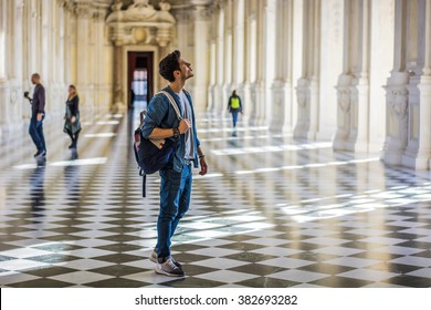 Handsome Man Holding a Guide Inside a Museum - Shutterstock ID 382693282