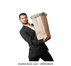 Handsome Man Holding Heavy Paper Bag With Money. Isolated On White Background