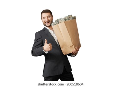 Handsome Man Holding Paper Bag With Money And Showing Thumbs Up. Isolated On White Background