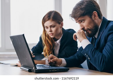  Handsome Man In Jacket And Not Interested Woman Sitting At Table In Office                         