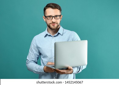 Handsome Man With Laptop On Color Background