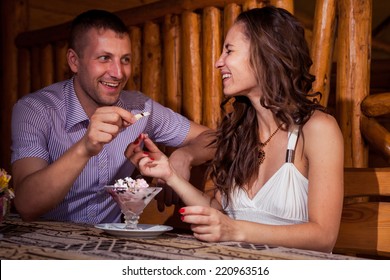 handsome man in lilac shirt get engagement to young beautiful brunette girl in white blouse