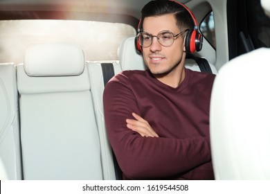 Handsome Man Listening To Audiobook In Car