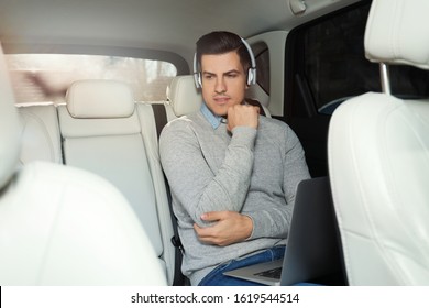 Handsome Man Listening To Audiobook In Car