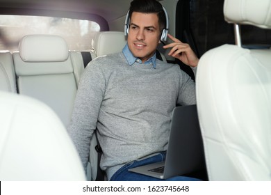 Handsome Man Listening To Audiobook In Car