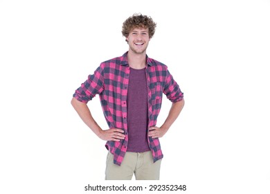 Handsome man looking at camera with hands on hips on white background