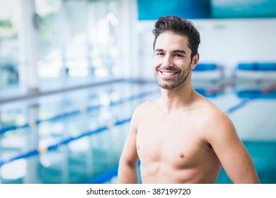 Handsome man looking at camera at the pool