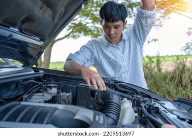 Handsome Man Looking At Car Engine.  The Car Broke Down On The Roadside.