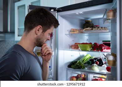 Handsome Man Looking For Food In Refrigerator