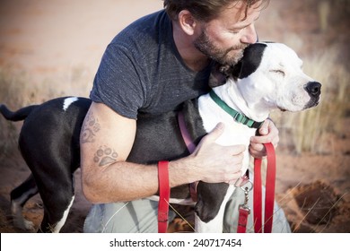 Handsome Man With Loving And Beautiful  Dog Paw Tattoo On Man's Arm 