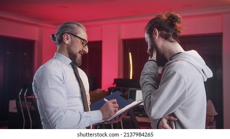 Handsome Man In Middle Aged Suit Employer Is Working On A Joint Project With His Young Employee