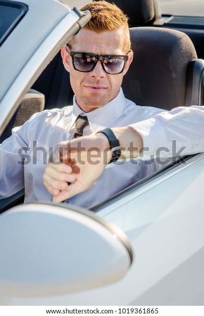 Handsome man near the car.
Luxury life.