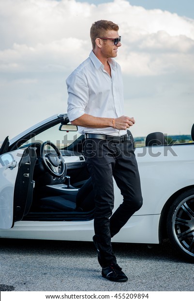 Handsome man near the car.\
Luxury life.