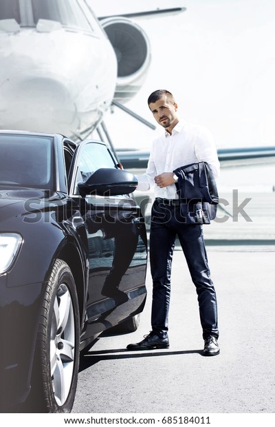 Handsome man near the car.\
Luxury life.