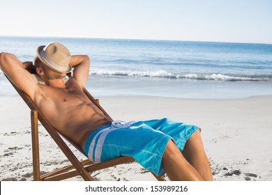 Handsome Man On The Beach Sleeping On His Deck Chair