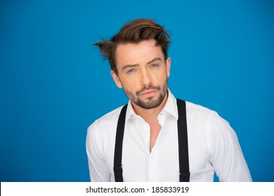 Handsome Man On Blue Wearing White Shirt And Braces On Blue With Crazy Hair Style