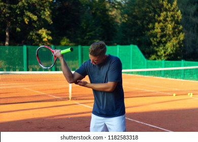 Handsome Man On Tennis Court. Young Tennis Player. Pain In The Elbow