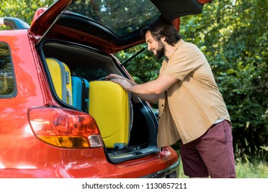 Handsome Man Packing Car Trunk With Baggage