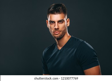 Handsome Man Posing In Studio On Dark Background