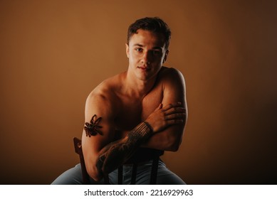 Handsome Man Posing With The Tarantula At The Studio While Sitting