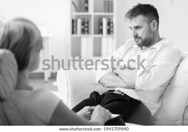 Handsome man with post traumatic stress\
during psychotherapy