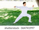 Handsome man practicing thai chi