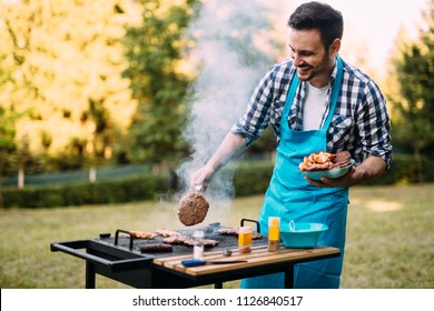Handsome man preparing barbecue