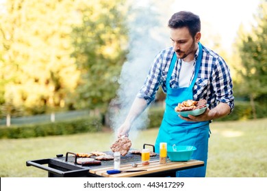 Handsome Man Preparing Barbecue For Friends