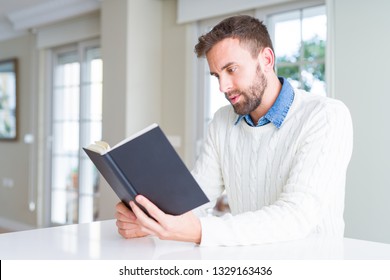 Handsome Man Reading A Book At Home