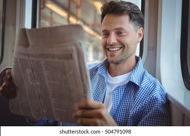 Handsome Man Reading Newspaper In Train