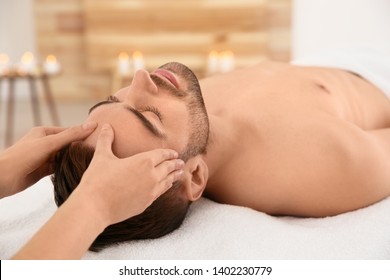 Handsome man receiving face massage in spa salon - Powered by Shutterstock