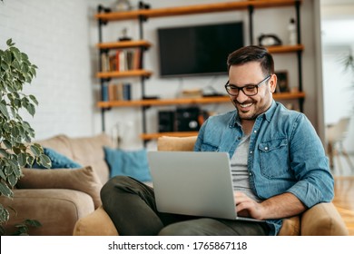 Handsome Man Relaxing At Home, Using Laptop, Portrait.