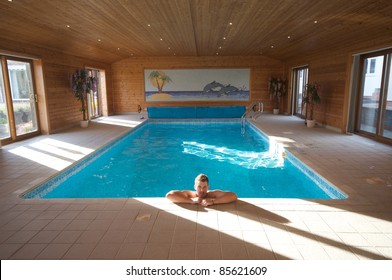 Handsome Man Relaxing In A Indoor Swimming Pool