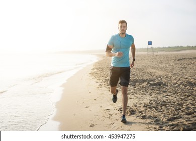 Handsome man running on the beach
 - Powered by Shutterstock