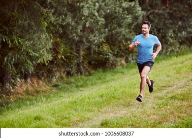 Handsome Man Running On Grass