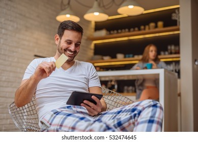 Handsome Man Shopping From Home With A Credit Card.