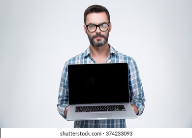 Handsome Man Showing Blank Laptop Computer Screen Isolated On A White Background