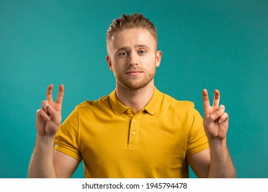 Handsome Man Showing With Hands And Two Fingers Air Quotes Gesture, Bend Fingers Isolated Over Blue Background. Not Funny, Irony And Sarcasm Concept.