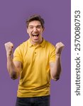 Handsome man shows triumph yes YEAH gesture of victory, he achieved result, goals. Guy glad, happy, surprised excited happy lady on violet background. Jackpot concept. High quality