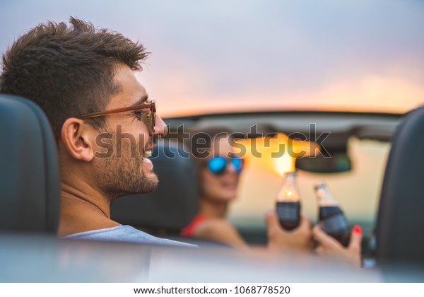 The handsome man
sit in a car with friends