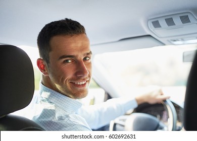 Handsome Man Sitting In A Car And Looking Back