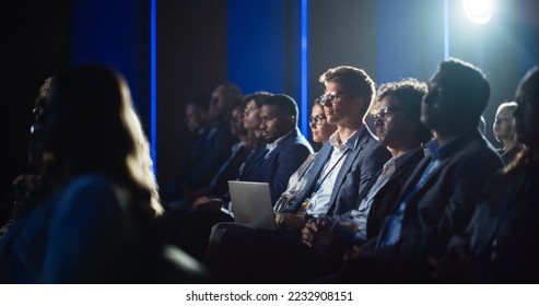 Handsome Man Sitting in a Crowded Audience at a Business Conference. Corporate Delegate Watching Inspirational Entrepreneurship Presentation About Developing Markets and Financial Opportunities. - Shutterstock ID 2232908151