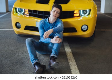 Handsome Man Sitting Near The Modern Sport Car