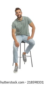 Handsome Man Sitting On Stool Against White Background