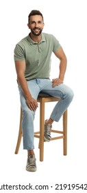 Handsome man sitting on stool against white background - Shutterstock ID 2191954247