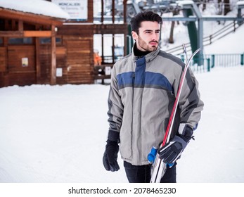 Handsome Man With Ski Standing In Snow