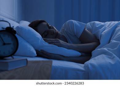 Handsome man sleeping in bed at night